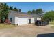 Detached two car garage with dark trim and white siding at 1055 Tilghman Rd, Dunn, NC 28334
