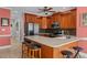 Spacious eat-in kitchen featuring bar seating, stainless steel appliances, and wood cabinetry at 1055 Tilghman Rd, Dunn, NC 28334