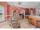 Bright eat-in kitchen featuring tile floors, a breakfast bar, a glass table, and modern appliances at 1055 Tilghman Rd, Dunn, NC 28334