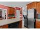 View of the kitchen with breakfast bar, stainless steel appliances, and wood cabinets at 1055 Tilghman Rd, Dunn, NC 28334