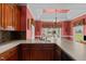 Spacious kitchen features an eat-in counter, tile backsplash, stainless steel appliances, and wood cabinets at 1055 Tilghman Rd, Dunn, NC 28334