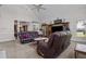 Cozy living room featuring vaulted ceilings, plush seating, and natural light at 1055 Tilghman Rd, Dunn, NC 28334