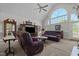 Open living room with vaulted ceiling, large windows, and comfortable seating at 1055 Tilghman Rd, Dunn, NC 28334