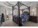 The main bedroom features a four-poster bed, tray ceiling, and a large window at 1055 Tilghman Rd, Dunn, NC 28334
