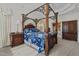 The main bedroom features a four-poster bed, tray ceiling, and a sitting area at 1055 Tilghman Rd, Dunn, NC 28334