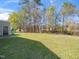Well-maintained backyard showcasing lush green grass, mature trees, and a serene outdoor space for relaxation and recreation at 106 Mingocrest Dr, Knightdale, NC 27545