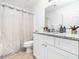 Sparkling bathroom with granite countertops, white cabinetry, modern fixtures, and a shower with decorative curtain at 106 Mingocrest Dr, Knightdale, NC 27545