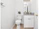 Bathroom with a toilet, vanity with granite countertop, and modern fixtures at 106 Mingocrest Dr, Knightdale, NC 27545