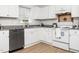 Well-equipped kitchen with white cabinets, stainless steel appliances, modern countertops and tile backsplash at 106 Mingocrest Dr, Knightdale, NC 27545