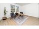 Cozy living room area featuring two chairs and a uniquely patterned rug, bathed in natural light from large windows at 106 Mingocrest Dr, Knightdale, NC 27545