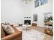 Bright living room with high ceilings, a fireplace, hardwood floors, and stylish furniture at 106 Mingocrest Dr, Knightdale, NC 27545