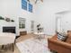 Open living room with a fireplace, hardwood floors, lots of natural light, and contemporary decor at 106 Mingocrest Dr, Knightdale, NC 27545