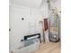 Functional utility room with shelving, water heater, and laminate flooring, offering practical storage solutions at 106 Mingocrest Dr, Knightdale, NC 27545