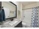 Bathroom featuring granite counters, modern fixtures, and a shower-tub combo at 1113 Cryptic Wood Ave, Fuquay Varina, NC 27526