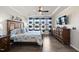 Well-lit bedroom featuring hardwood floors, neutral walls, ceiling fan and natural light from the windows at 1113 Cryptic Wood Ave, Fuquay Varina, NC 27526