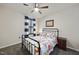 This bedroom is well lit and features a colorful quilt, metal bed frame, and neutral paint at 1113 Cryptic Wood Ave, Fuquay Varina, NC 27526