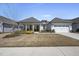 Charming single-story home with a covered porch and well-manicured front yard and two car garage at 1113 Cryptic Wood Ave, Fuquay Varina, NC 27526