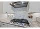 Close-up of kitchen with stainless steel appliances and decorative tile backsplash at 1113 Cryptic Wood Ave, Fuquay Varina, NC 27526