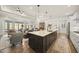 Open kitchen featuring a large island, modern appliances, and seamless flow into the living area at 1113 Cryptic Wood Ave, Fuquay Varina, NC 27526