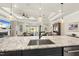 Kitchen island with granite countertop and sink, seamlessly connected to the living space at 1113 Cryptic Wood Ave, Fuquay Varina, NC 27526
