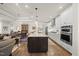 Bright kitchen showcasing a central island with granite countertops and stylish white cabinetry at 1113 Cryptic Wood Ave, Fuquay Varina, NC 27526