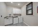 Laundry room features modern appliances, granite counters, and upper cabinets at 1113 Cryptic Wood Ave, Fuquay Varina, NC 27526