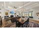 Open-concept living room with a fireplace, dining area, and access to an outdoor patio at 1113 Cryptic Wood Ave, Fuquay Varina, NC 27526