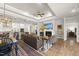 Open-concept living room featuring hardwood floors, a fireplace, and seamless flow to the kitchen area at 1113 Cryptic Wood Ave, Fuquay Varina, NC 27526