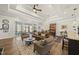 Cozy living room featuring a tray ceiling, plush seating, and seamless flow into the dining area at 1113 Cryptic Wood Ave, Fuquay Varina, NC 27526