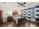 Cozy bedroom with hardwood floors, ceiling fan, and charming blue and white striped curtains at 1113 Cryptic Wood Ave, Fuquay Varina, NC 27526