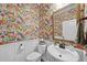 Charming powder room featuring floral wallpaper, a white vanity, and a gold-framed mirror at 1113 Cryptic Wood Ave, Fuquay Varina, NC 27526