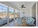 Bright sunroom features tiled floor, modern furniture, and large windows at 1113 Cryptic Wood Ave, Fuquay Varina, NC 27526