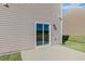 View of a back patio with beige siding and a sliding glass door at 1113 Ursa Major Ct, Wendell, NC 27591