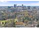 Aerial view capturing a stunning city skyline surrounded by lush green trees and vibrant spring colors at 1121 Parkridge Ln # 207, Raleigh, NC 27605
