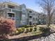 Inviting condo with charming balconies, lush landscaping, and a well-maintained facade, creating a welcoming curb appeal at 1121 Parkridge Ln # 207, Raleigh, NC 27605