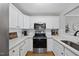 Modern kitchen featuring white cabinets, stainless steel appliances, and quartz countertops at 1121 Parkridge Ln # 207, Raleigh, NC 27605
