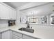 Bright kitchen with white cabinets, quartz countertops, subway tile backsplash, and stainless steel sink at 1121 Parkridge Ln # 207, Raleigh, NC 27605
