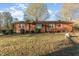 Charming brick home featuring a cozy entrance and well-maintained front yard at 1122 Snow Hill Rd, Durham, NC 27712