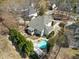 Aerial view of a backyard featuring a sparkling pool, patio area, and lush landscaping at 116 Arlen Park Pl, Holly Springs, NC 27540