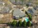 An aerial view of the property showing a lovely backyard pool, and mature trees surrounding the home at 116 Arlen Park Pl, Holly Springs, NC 27540