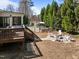 Backyard with a stone firepit, wooden deck, and swimming pool at 116 Arlen Park Pl, Holly Springs, NC 27540