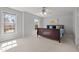 This bedroom has carpet, two windows and soft, neutral colored walls at 116 Arlen Park Pl, Holly Springs, NC 27540