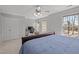 This bedroom features a ceiling fan, windows, a closet, and a desk with office equipment at 116 Arlen Park Pl, Holly Springs, NC 27540