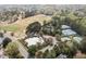 Aerial shot of a community pool and tennis courts surrounded by trees at 116 Arlen Park Pl, Holly Springs, NC 27540