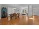 A bright dining room showcases an elegant chandelier, a wine refrigerator and an open flow to the adjacent living room at 116 Arlen Park Pl, Holly Springs, NC 27540