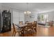 A bright dining room showcases an elegant chandelier, a wine refrigerator and an open flow to the adjacent living room at 116 Arlen Park Pl, Holly Springs, NC 27540
