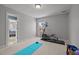 This exercise room has a treadmill, a yoga mat, dumbbells, and a view of the backyard at 116 Arlen Park Pl, Holly Springs, NC 27540