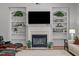 Living room fireplace with built-in shelving, offering a cozy space for relaxing and entertaining at 116 Arlen Park Pl, Holly Springs, NC 27540