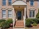 Beautiful brick home with a covered front entrance, white columns and landscaped bushes at 116 Arlen Park Pl, Holly Springs, NC 27540