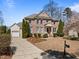 Charming two-story brick home featuring manicured landscaping, traditional architectural details, and an inviting front porch at 116 Arlen Park Pl, Holly Springs, NC 27540